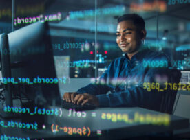 一个人在电脑上工作，几行代码叠加在他身上。